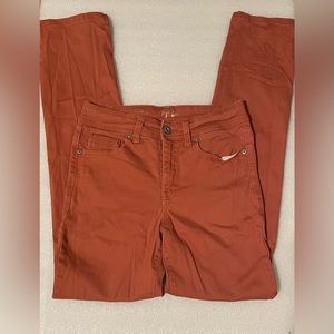 Brown and orangish pair of jeans